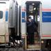 An Amtrak conductor glances out of a doorway for last minute passengers as the westbound train leaves for Chicago at the Ann Arbor station on Wednesday. Melanie Maxwell I AnnArbor.com